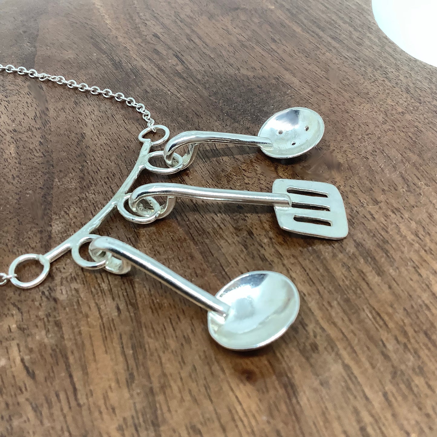 Sterling silver cooking utensils necklace.